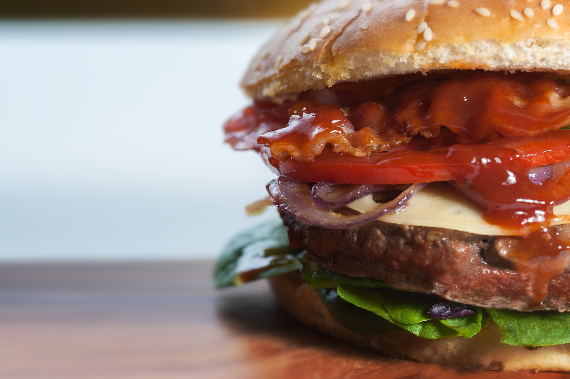A burger on a wooden slab