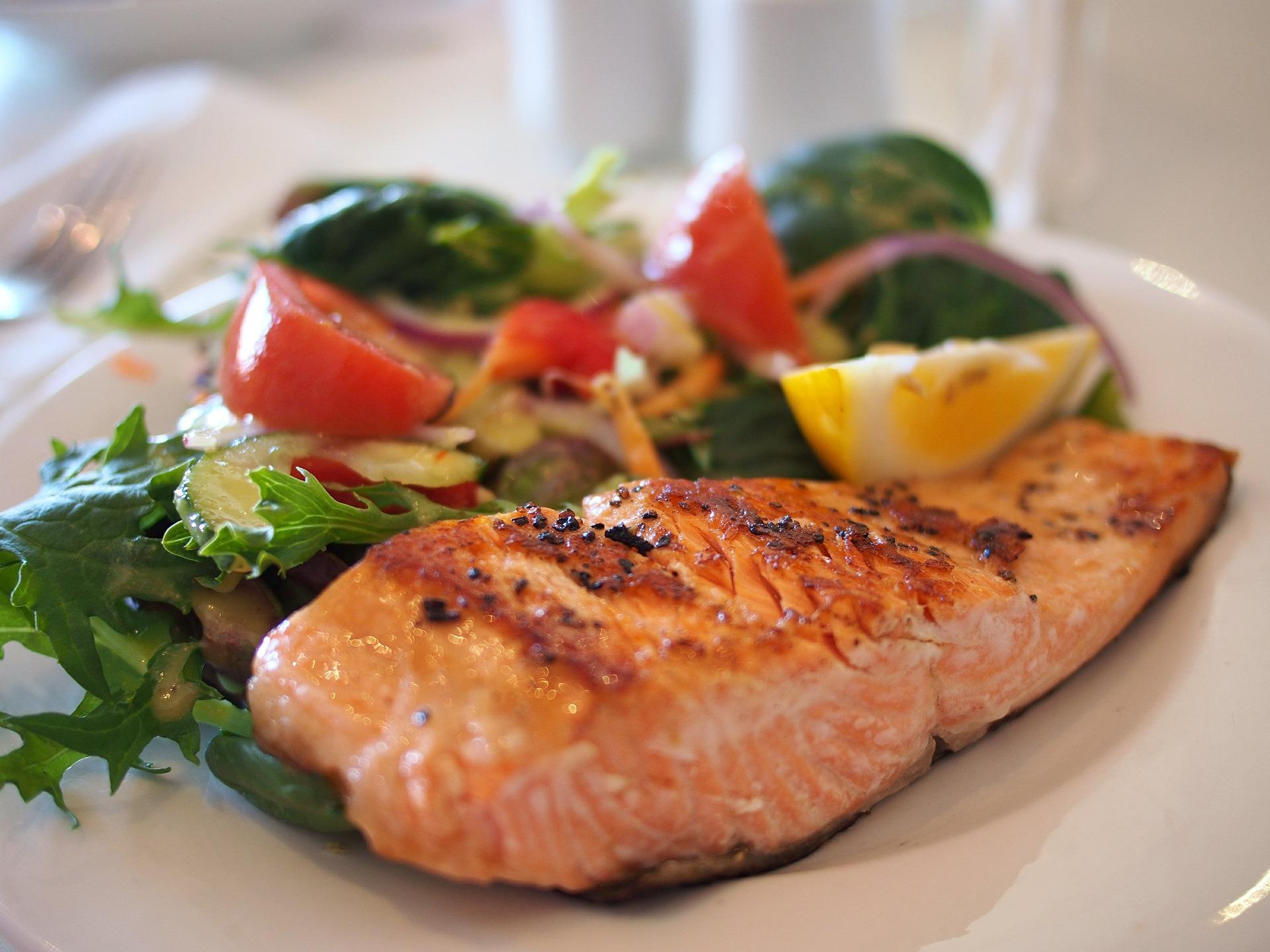 A plate of cooked fish and vegetables