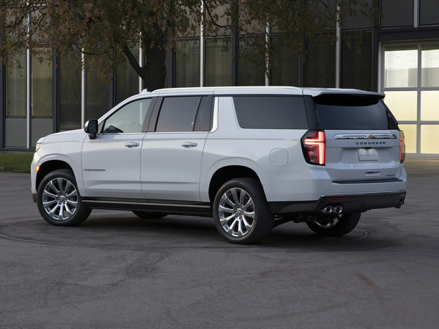 A white Chevrolet Suburban parked outside