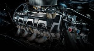 Chevrolet crate engine close-up showcasing valve covers, air filter, and exhaust headers — high-performance Chevy engine for muscle cars and custom builds.