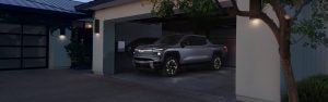 Chevrolet pickup truck parked in a modern home garage at dusk.