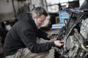 Mechanic working on servicing a car near Anderson, IN