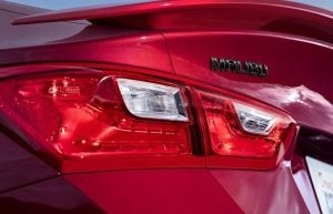A close-up photograph of the rear headlight on a red 2024 Chevy Malibu near Anderson, Indiana