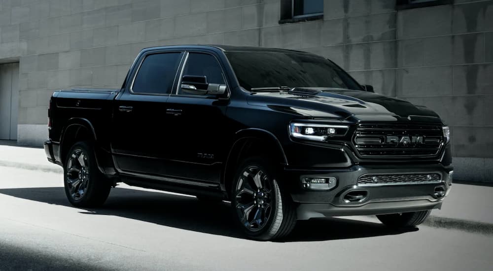A black 2023 Ram 1500 is shown from the front at an angle.