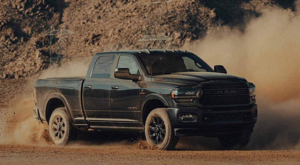 A black 2023 Ram 2500 is shown from the front at an angle.