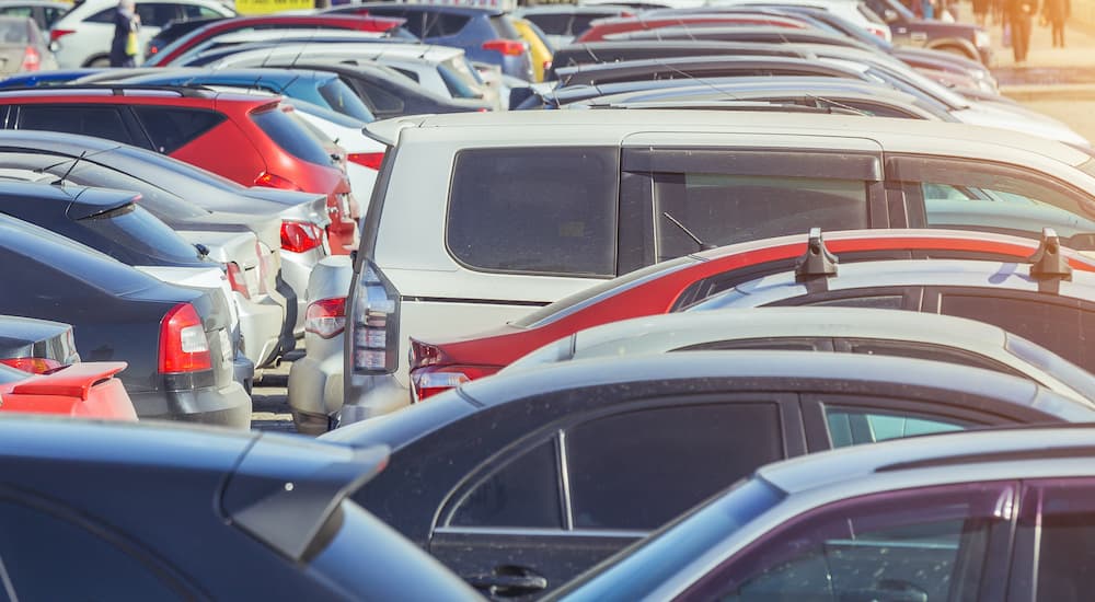 Two rows of used cars parked at a Certified pre-owned Chrysler dealer.