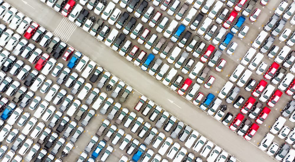 Aerial view of a large lot of certified pre-owned vehicles parked in tidy rows.