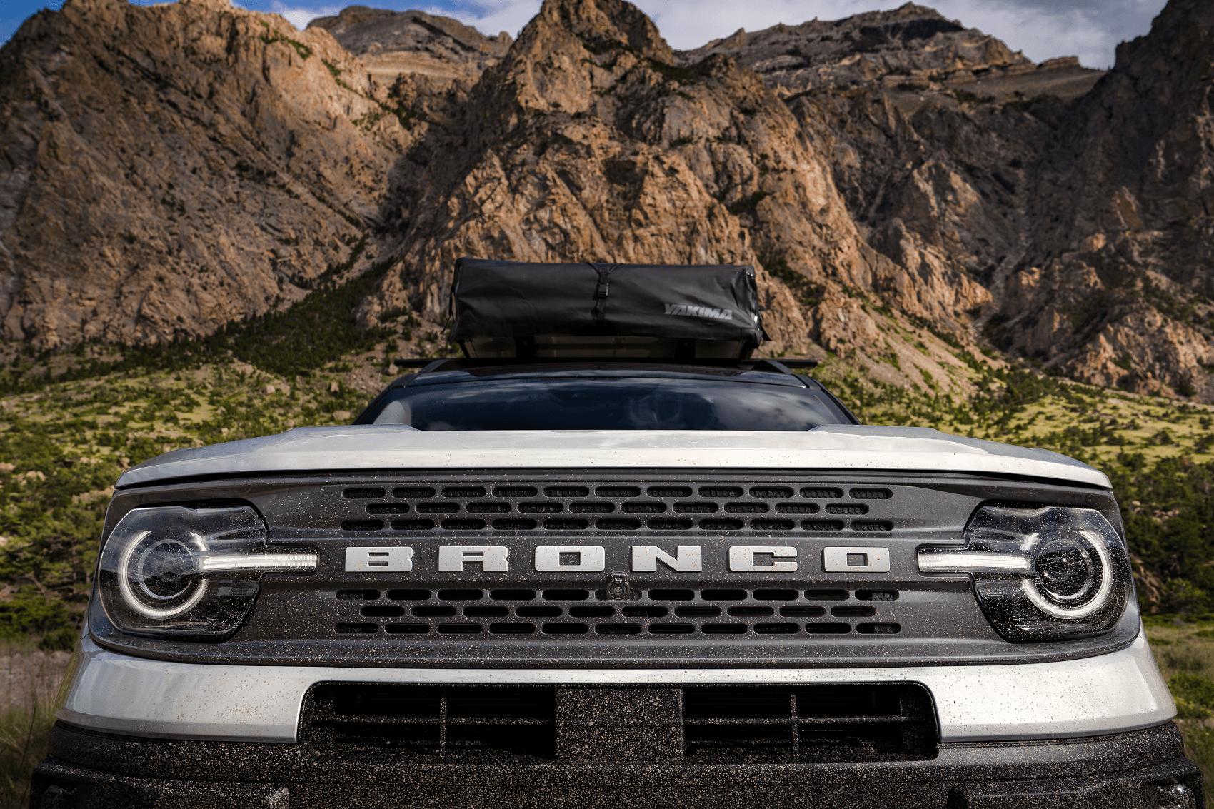 Close up view of front bummer of Ford Bronco parked with mountains in the background