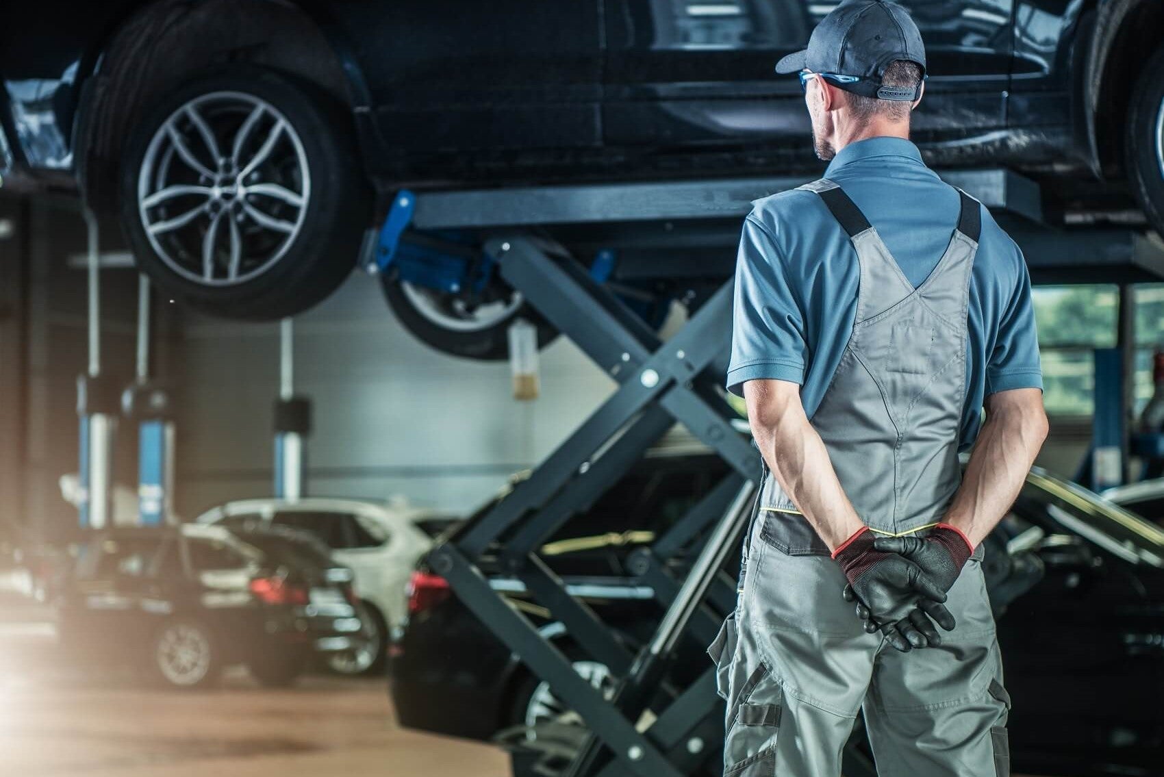 Ford Certified Technician overlooking vehicle maintenance at Service Center