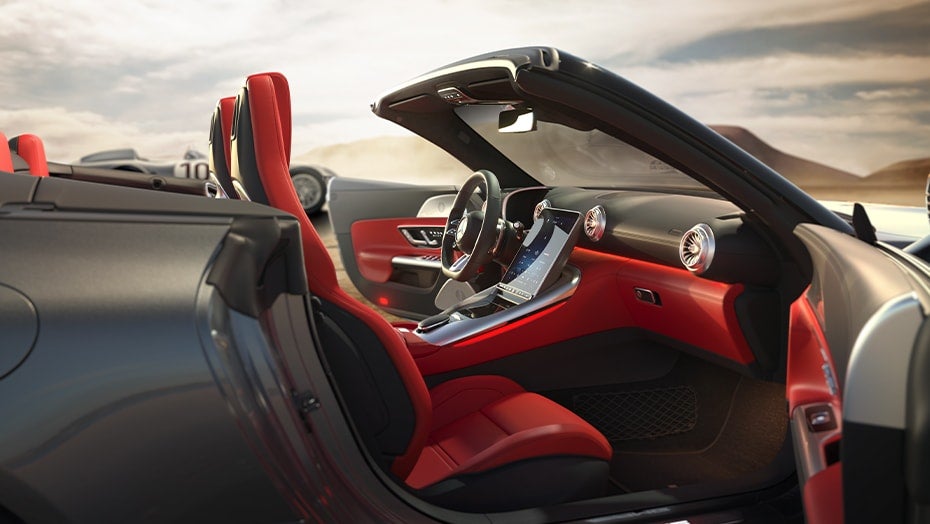 Mercedes-AMG® SL driving along the scenic North Shore Route near Lake Michigan with colorful fall foliage.