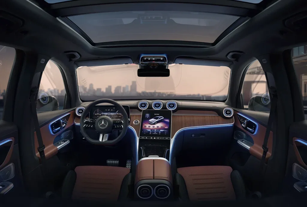 Interior view of the 2026 Mercedes-Benz GLC showing the panoramic roof, digital dashboard, ambient lighting, and premium cabin design.