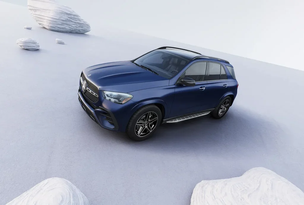 High-angle front view of a blue 2027 Mercedes-Benz GLS SUV with a panoramic roof, sculpted hood, and premium exterior design.