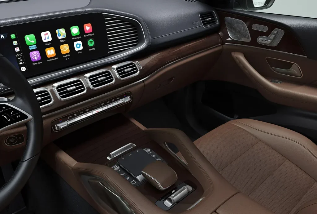 2027 Mercedes-Benz GLS dashboard with infotainment screen, wood trim, and luxury SUV controls.