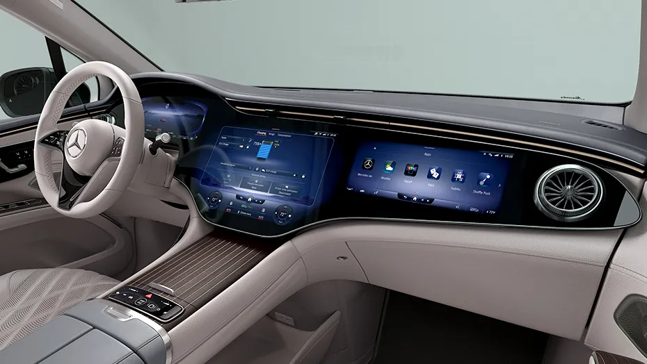 Interior dashboard and widescreen display inside the Mercedes-Benz EQS, showing the advanced technology that complements its fuel efficiency for families.