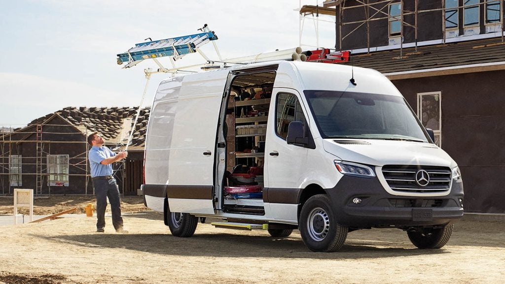 Technician checking interior storage and systems during a Mercedes-Benz Sprinter winter service inspection