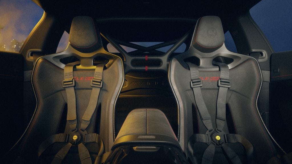 Bucket seats, racing harnesses, and roll cage inside the Mercedes-AMG CLE 646 Spezialanfertigung. 