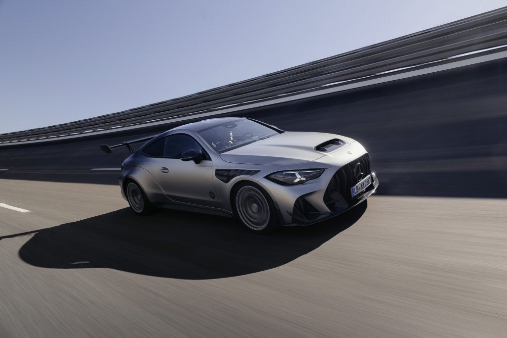 Silver Mercedes-AMG CLE 646 Spezialanfertigung speeding along a racetrack. 