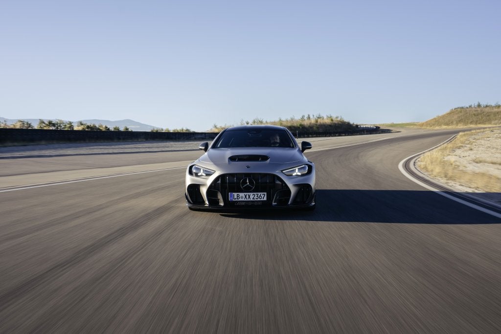 Front view of the Mercedes-AMG CLE 646 Spezialanfertigung driving through a racetrack corner. 