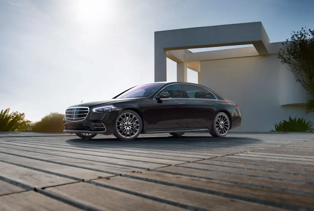 2027 Mercedes-Benz S-Class flagship sedan parked outside a modern luxury home