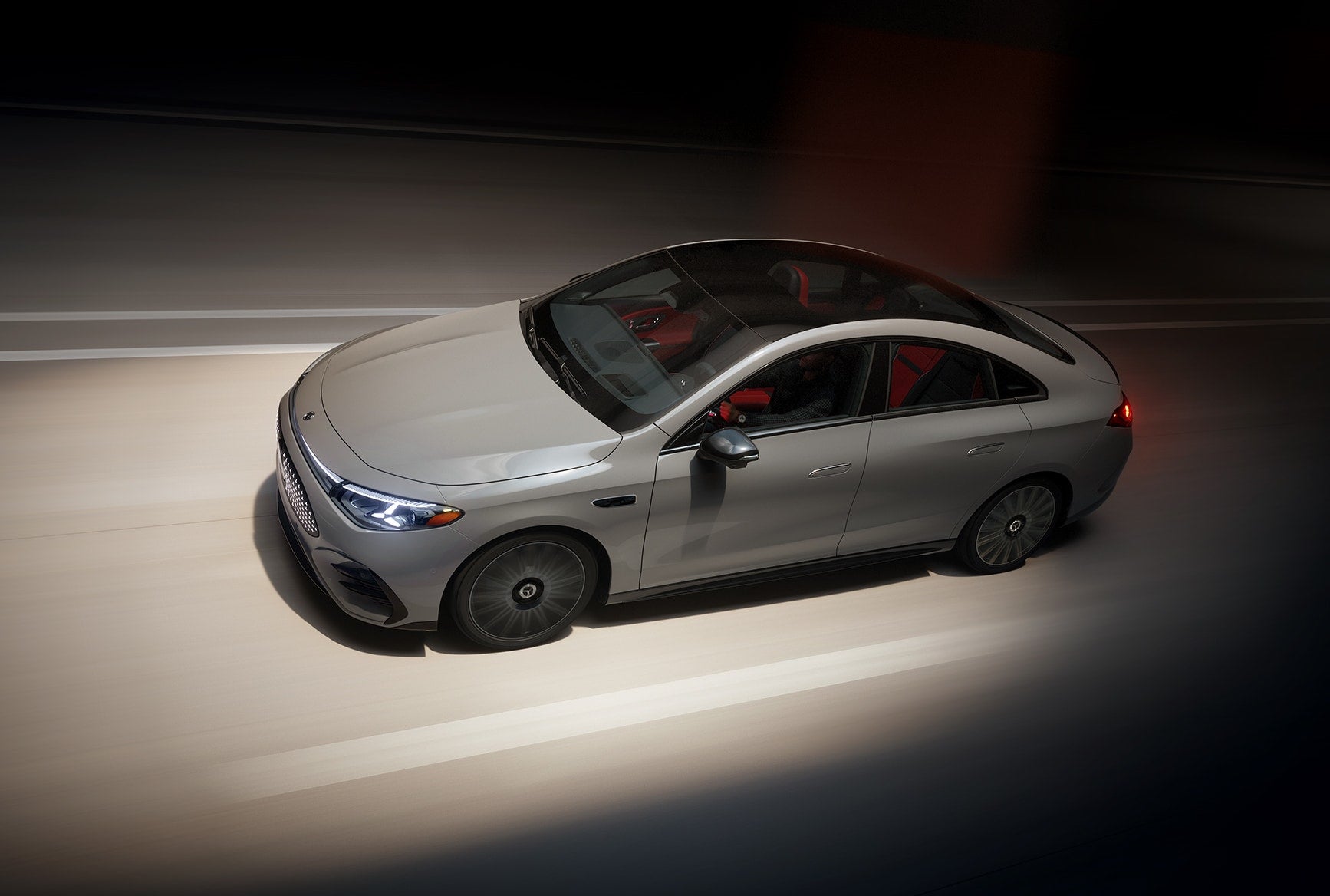 All-electric 2026 Mercedes-Benz CLA driving through a tunnel, showing its sleek sedan design and luxury EV styling.