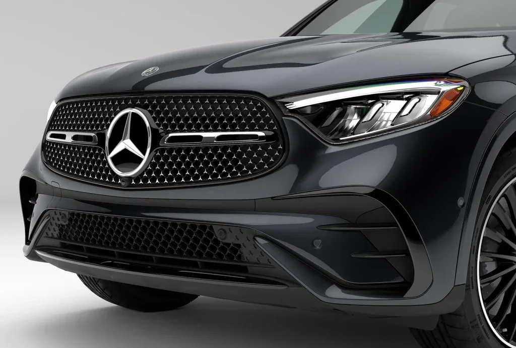 Close-up of the front grille and headlight design on a black 2026 Mercedes-Benz GLC, emphasizing its premium styling and luxury SUV character.
