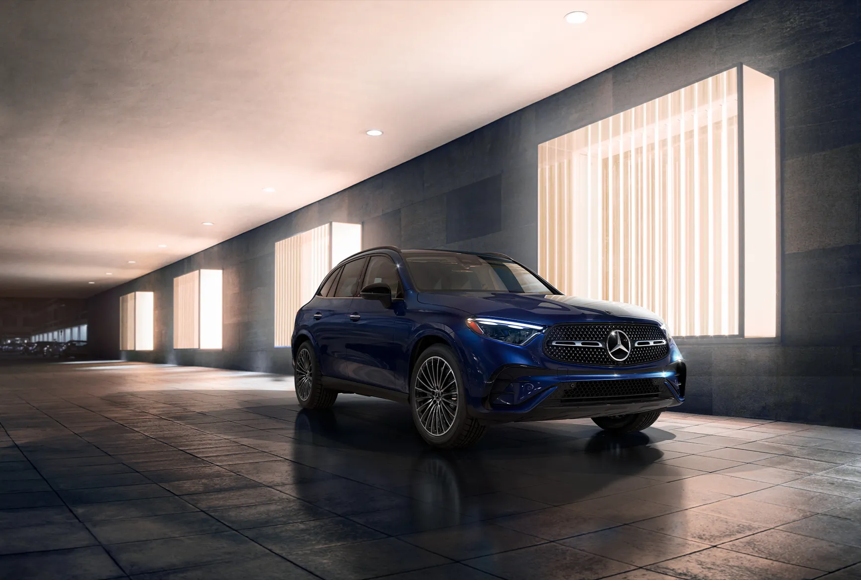 Blue 2026 Mercedes-Benz GLC parked in a modern illuminated space, showing the luxury SUV’s refined design and premium road presence.
