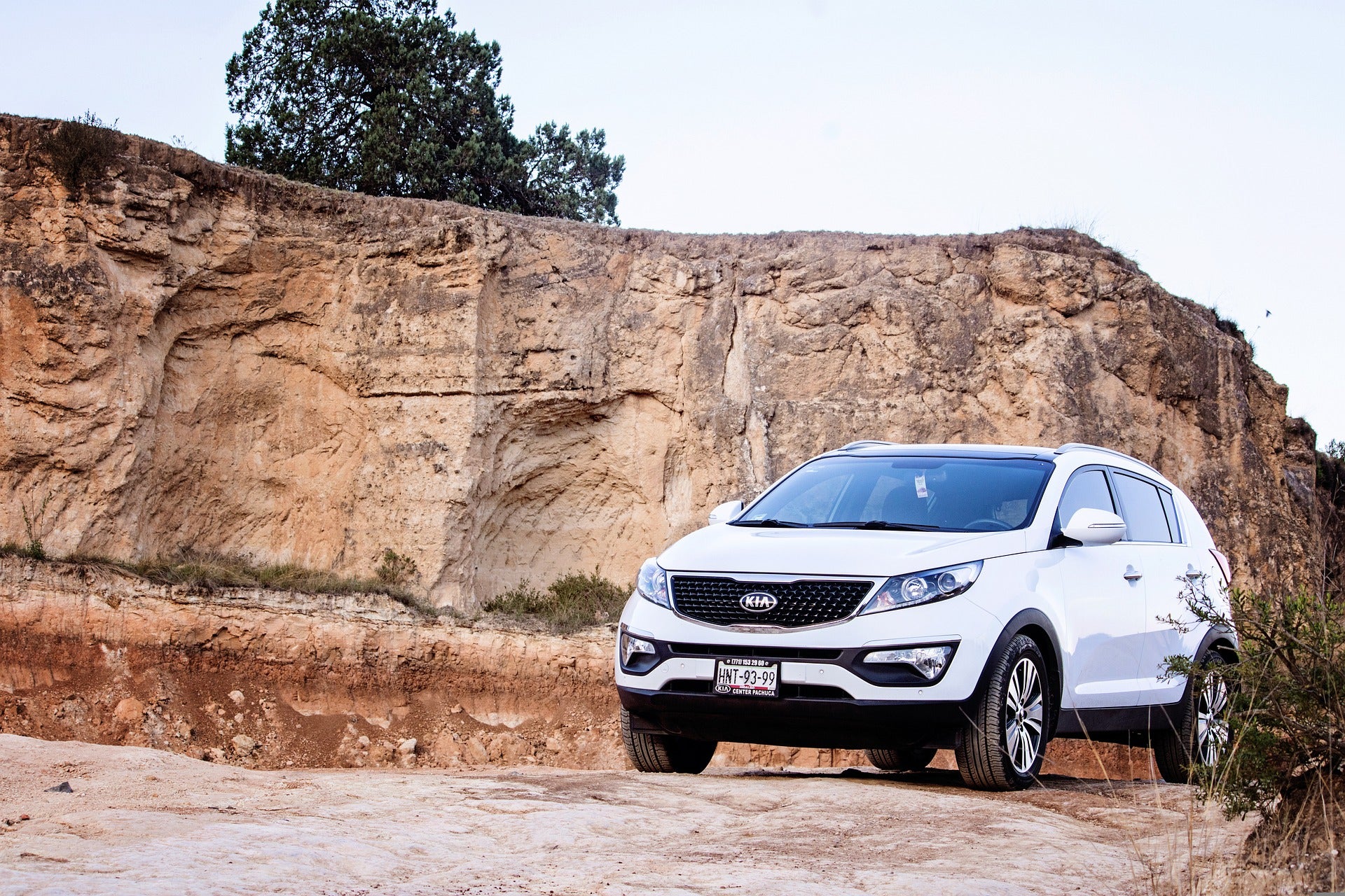 A white Kia vehicle out in the desert