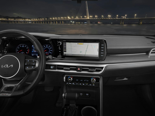 The front seat of a Kia facing a bridge