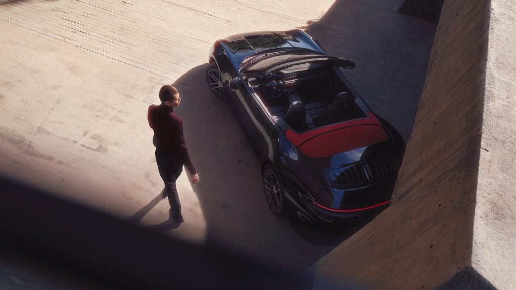 Customer selecting a Porsche Certified Pre-Owned vehicle at a dealership, representing the premium purchase experience.