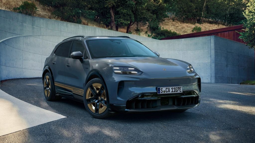 Porsche Cayenne parked in a modern setting, emphasizing chassis systems that make it a benchmark luxury performance SUV.