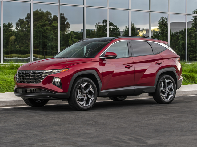 A red Hyundai Tucson parked outside of a building