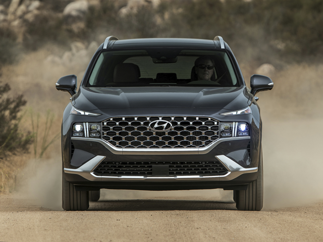 A person driving a Hyundai Santa Fe in a desert