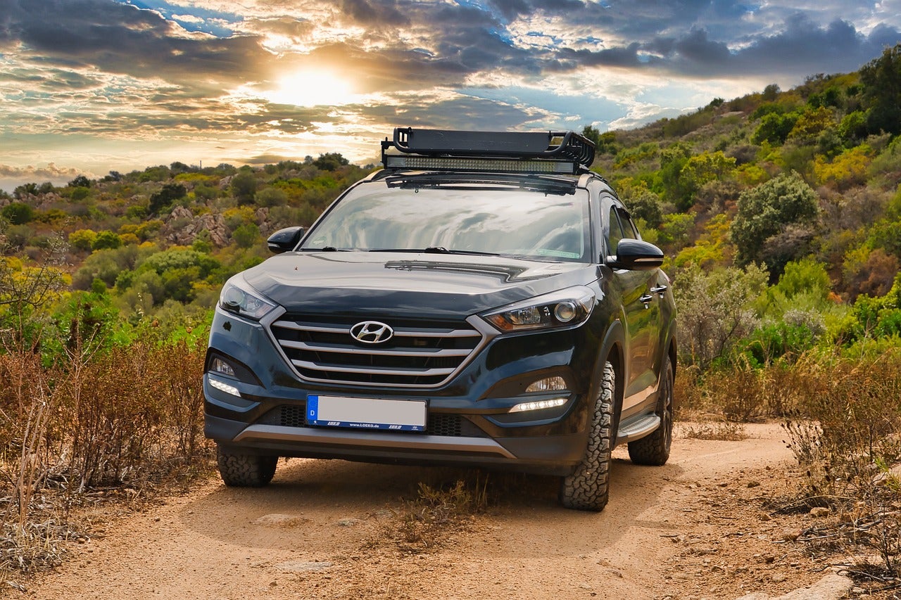 A Hyundai car driving outside close to sunset