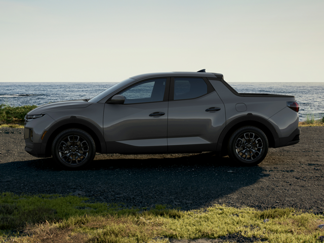 A silver Hyundai Santa Cruz parked near the water