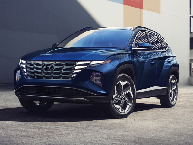 A blue Hyundai Tucson parked outside