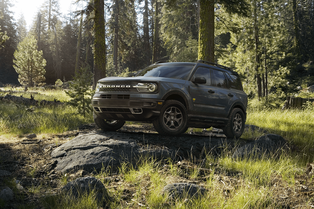 Ford Bronco Sport parked on a rock in the woods from a Ford Dealer near White Bear Lake MN
