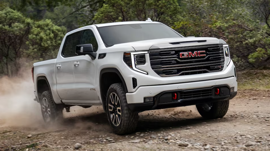 White 2023 GMC sierra 1500 front/side view driving on dirt path