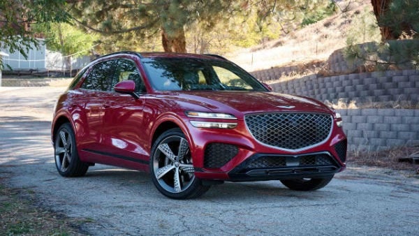 Red 2025 Genesis GV70 in driveway