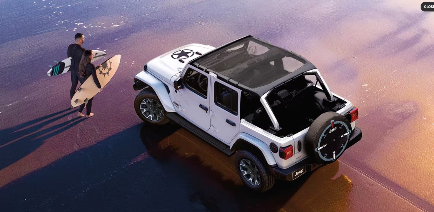 2026 Jeep Wrangler interior showing passenger space, Uconnect infotainment, and available Nappa leather seating