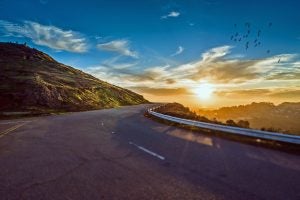 A winding road going into a sunset