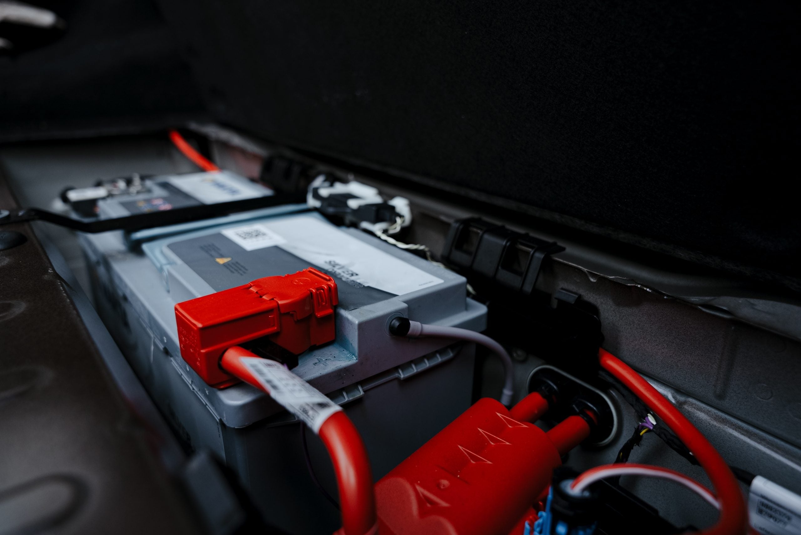 Close up shot of car battery inside the engine.