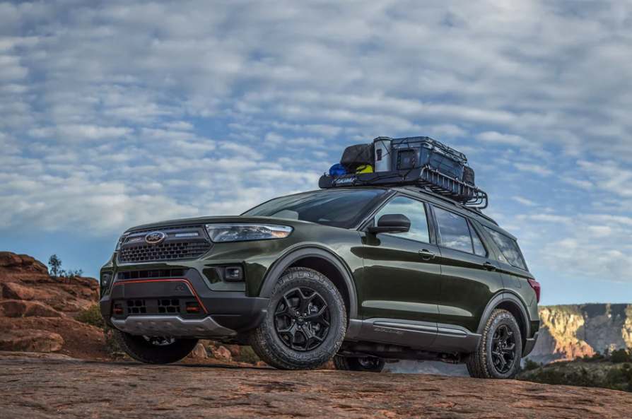 Green Ford Explorer parked on rocky hill showing front and side view of vehicle