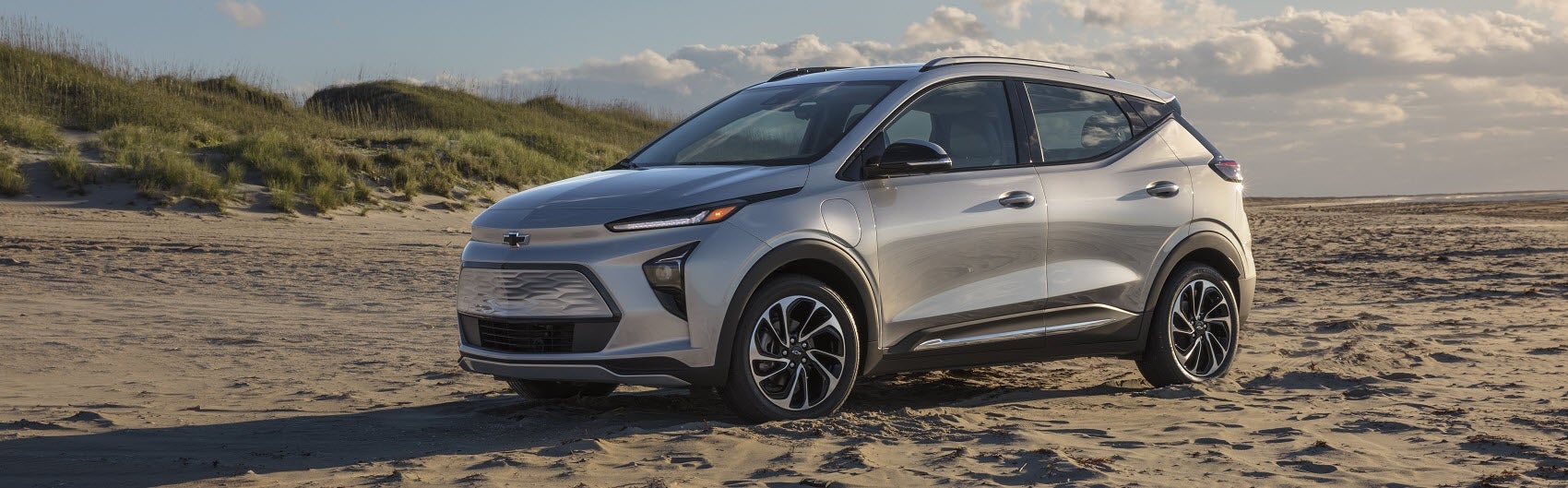2021 silver Chevy Bolt parked on beach