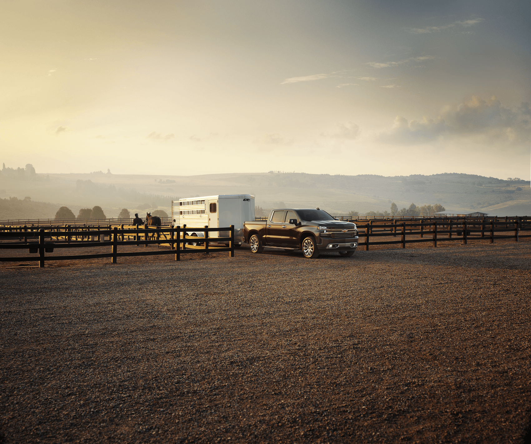 Black Chevy Silverado 1500 vs Ford F-150 hauling horse trailer 