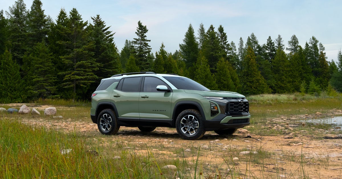 2025 Chevrolet Equinox in Cacti Green/Summit White color parked off-road in a field.
