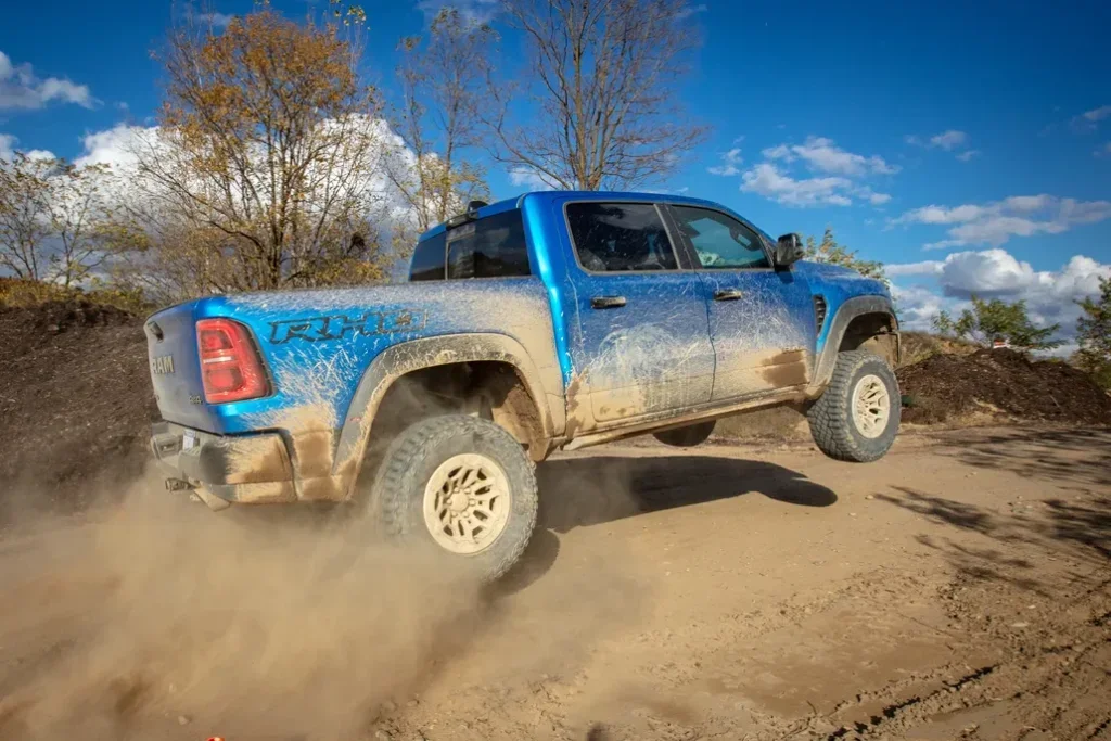 Ram 1500 Driving on a Desert Trail Rear 3/4 View
