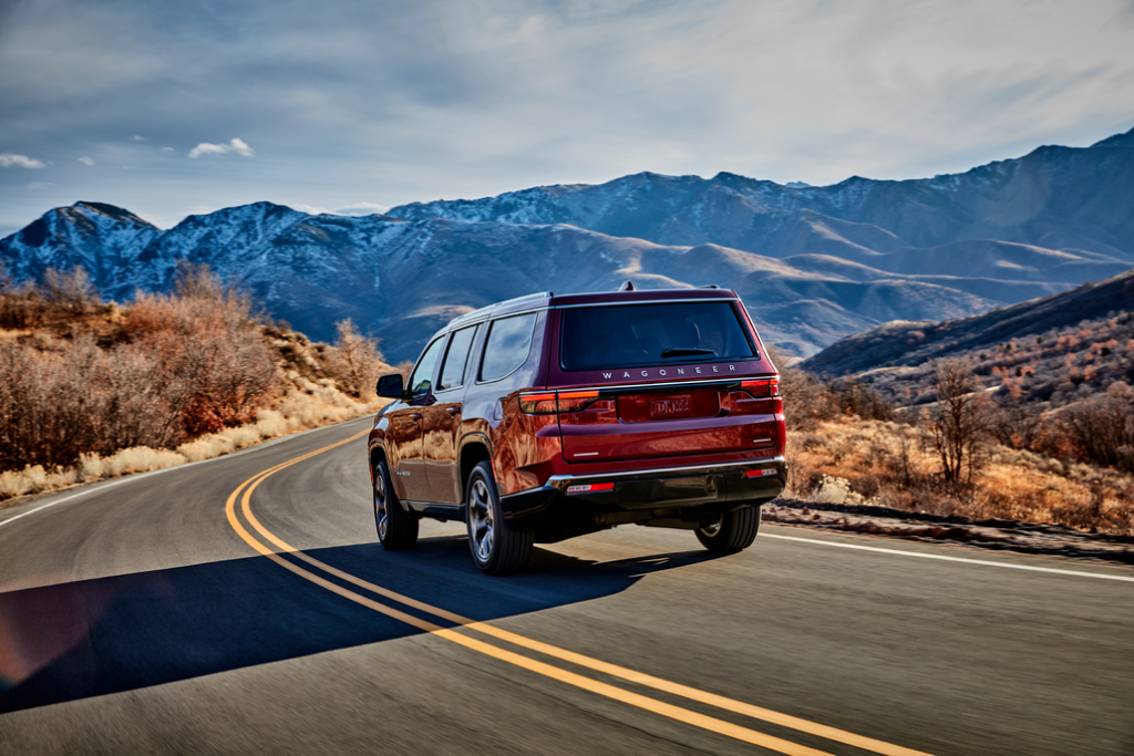 Jeep Wagoneer Driving Towards Mountains Rear 3/4 View