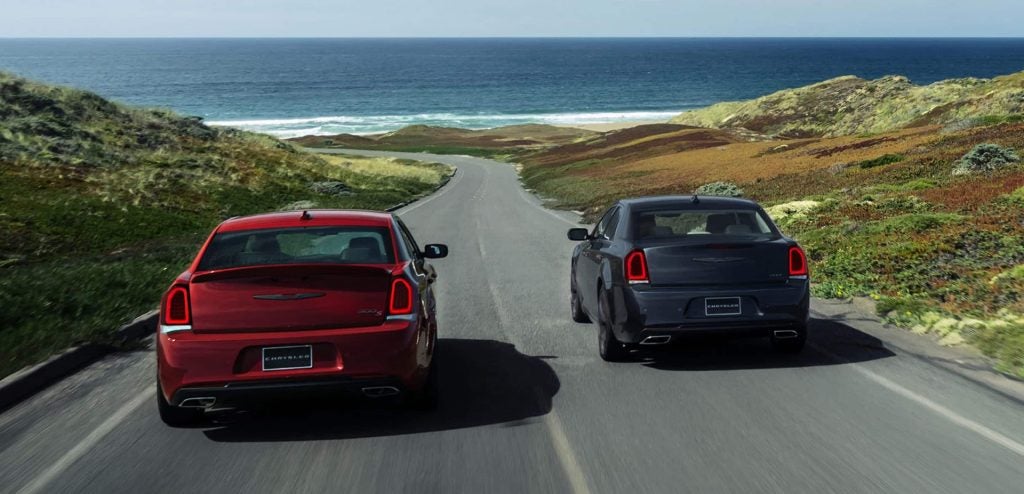 Red and Grey 2023 Chrysler 300s driving along the shore