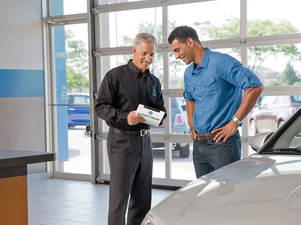 A Chrysler Dodge Jeep Ram Parts Professional Giving an Explanation to a Customer
