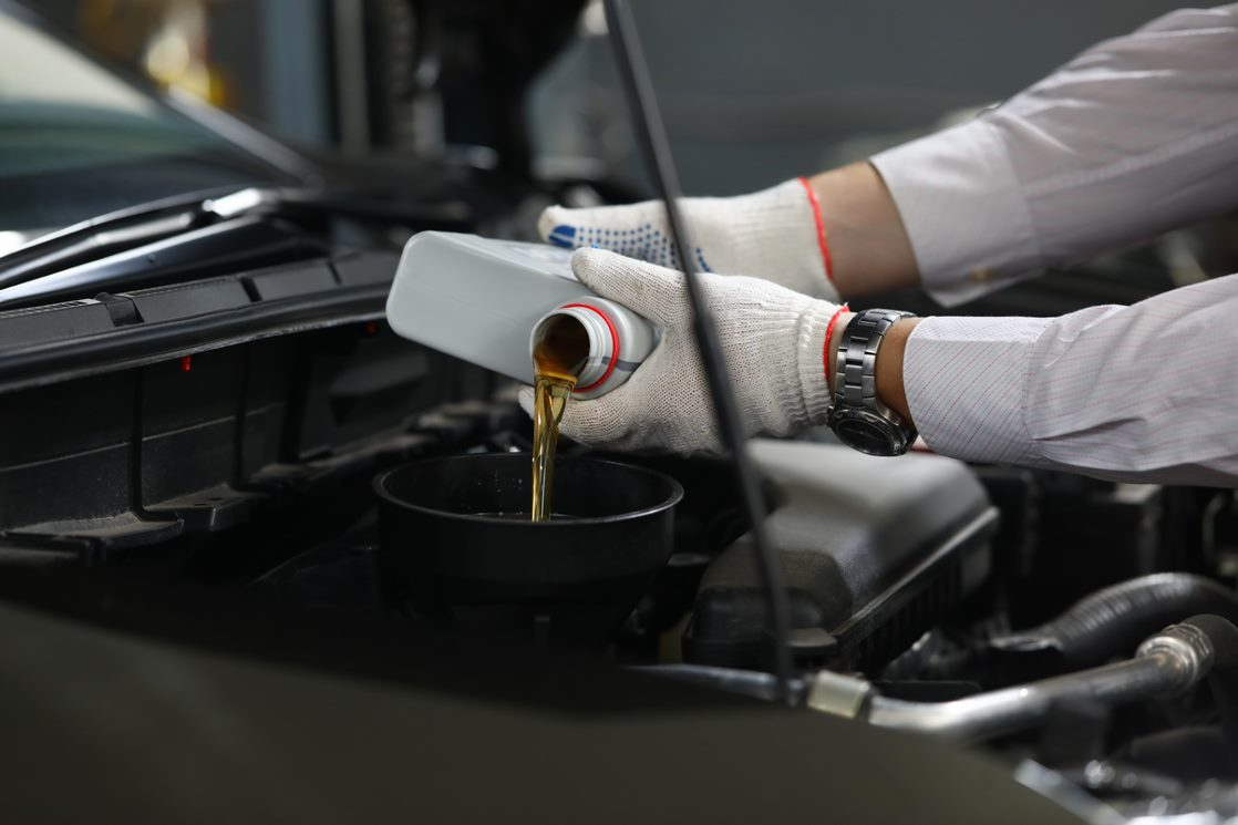 A mechanic completing an oil change